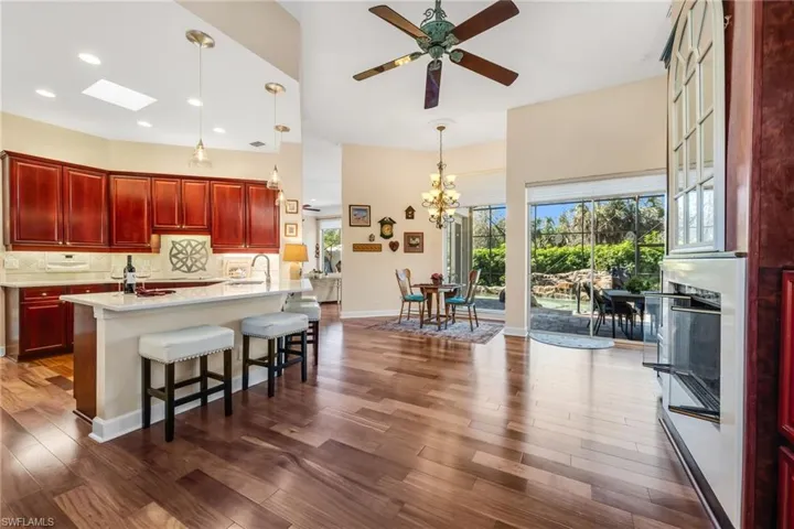 Kitchen has quartz countertops and opens to Breakfast area with two set of slider doors to allow the outside in concept.  Gas Fireplace for the few cool days of Florida.