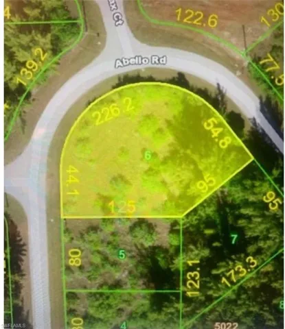 Aerial view of property and surrounding area featuring property parcel outlined
