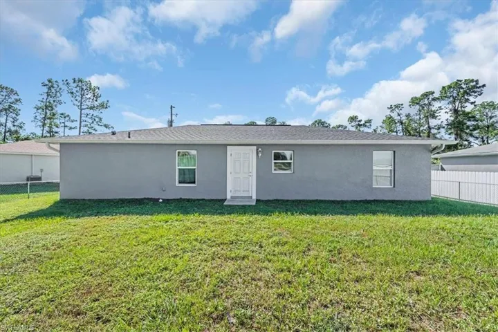 Rear view of house featuring stucco siding
