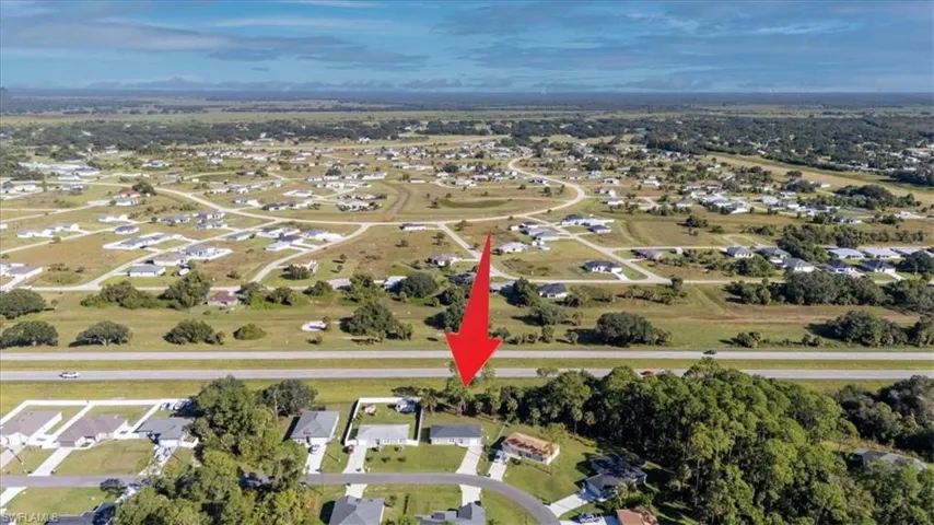 Aerial overview of property's location featuring nearby suburban area