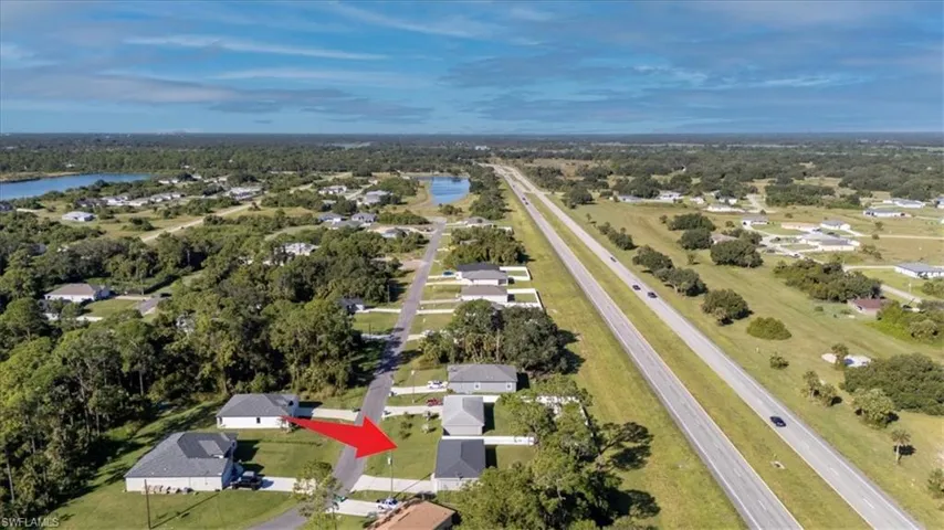 Aerial view of property's location featuring nearby suburban area and a large body of water