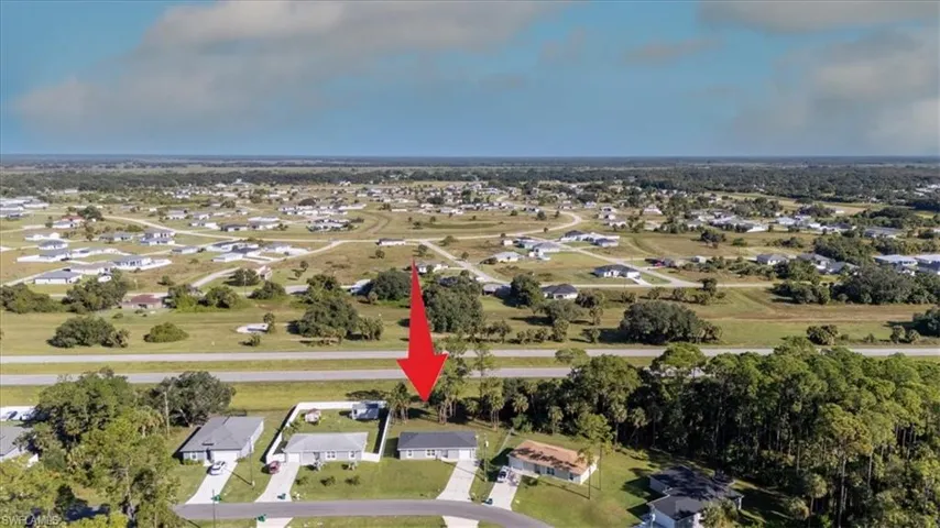 Aerial view of property's location with nearby suburban area