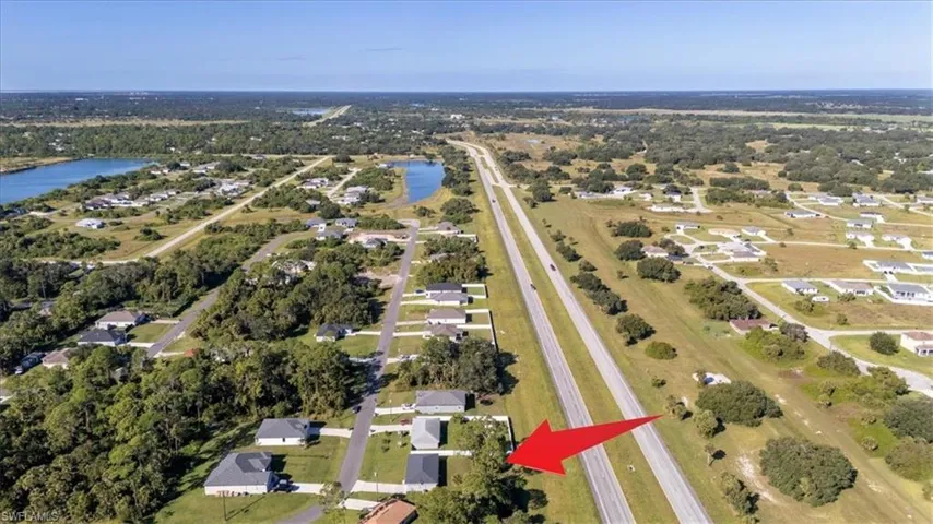 View of property location with a large body of water and nearby suburban area