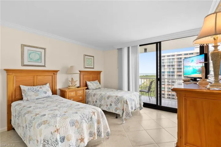 Tiled bedroom with ornamental molding, floor to ceiling windows, and access to outside