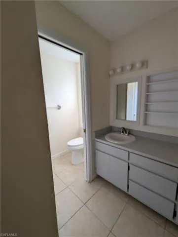 Bathroom with vanity and light tile patterned flooring