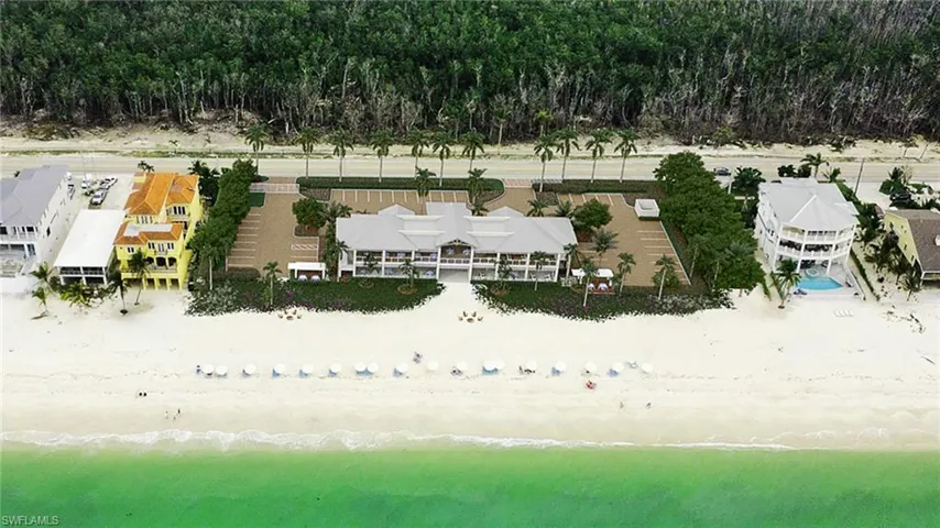 Coastal property featuring direct beach frontage with white sand and clear turquoise water