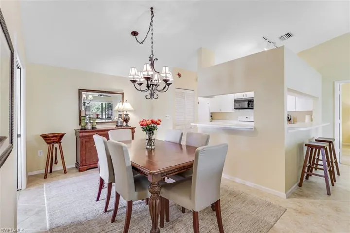 Dining area featuring a decorative chandelier and tiled flooring