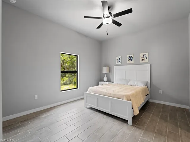 Bedroom featuring ceiling fan and light hardwood / wood-style flooring