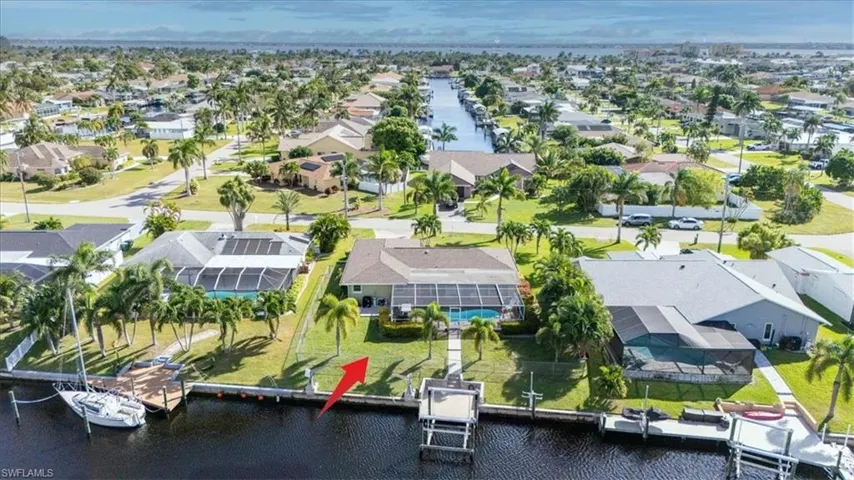 Aerial view of residential area featuring a large body of water