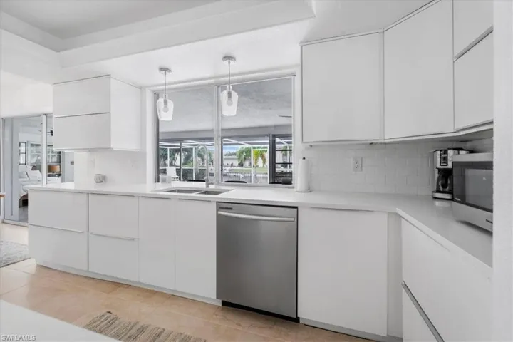 Kitchen featuring modern cabinets, white cabinetry, and stainless steel appliances