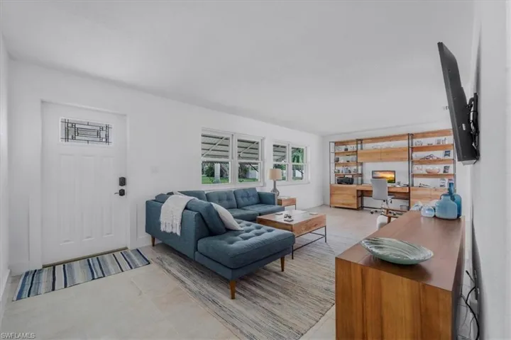 Living room with an office area and plenty of natural light