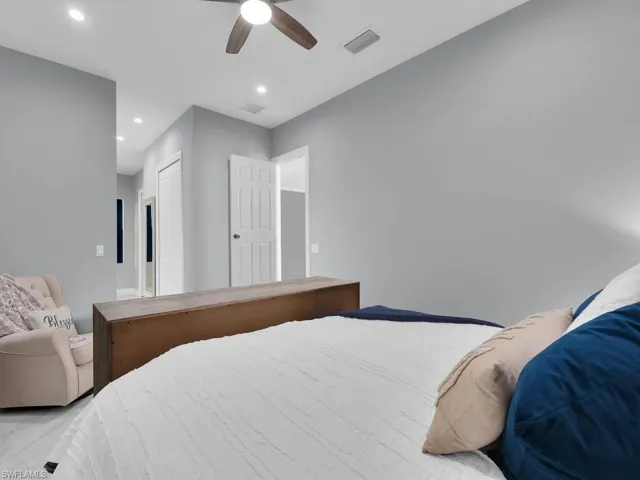 Bedroom with a closet, a ceiling fan, visible vents, and recessed lighting