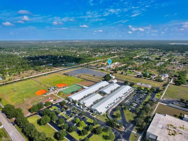 Birds eye view of property with a water view