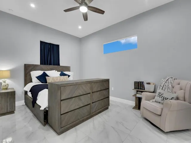 Bedroom with baseboards, a ceiling fan, marble finish floor, and recessed lighting