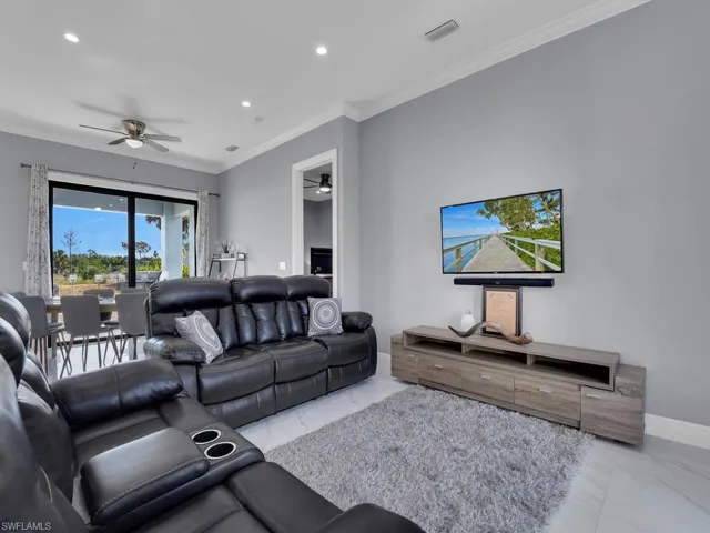 Living room with visible vents, a ceiling fan, and marble finish floor
