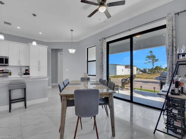 Dining area featuring baseboards, visible vents, recessed lighting, ceiling fan, and ornamental molding