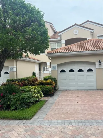 Mediterranean / spanish house featuring a tiled roof, stucco siding, and decorative driveway