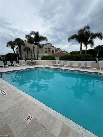 Community pool with a patio