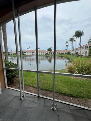 Entryway featuring a water view and dark tile patterned flooring