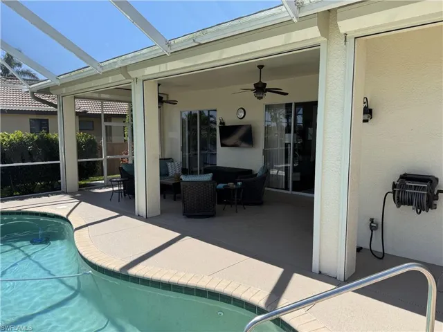 Outdoor pool with a patio area, a lanai, and ceiling fan