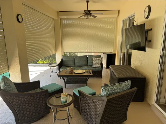 Sunroom featuring an outdoor living space and ceiling fan
