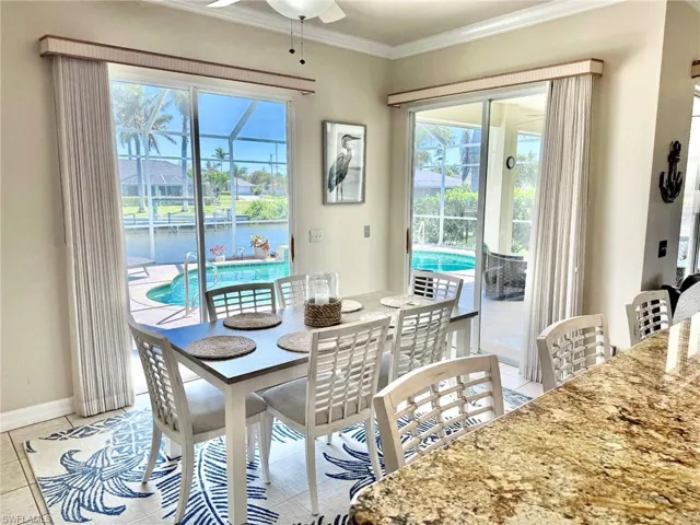 Dining area featuring plenty of natural light, baseboards, ornamental molding, and ceiling fan