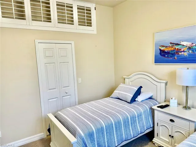 Carpeted bedroom with baseboards