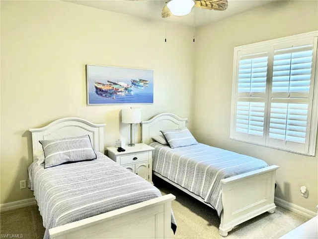 Bedroom with carpet flooring and baseboards