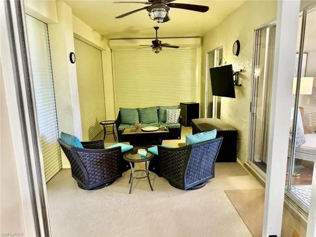 Sunroom featuring an outdoor living space and a ceiling fan