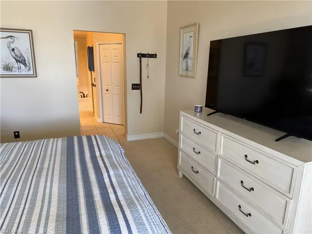 Bedroom featuring baseboards and light colored carpet