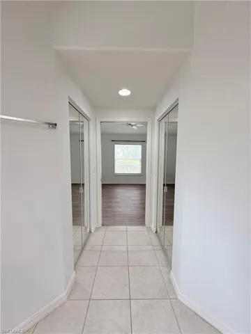 Corridor featuring light tile patterned floors and recessed lighting