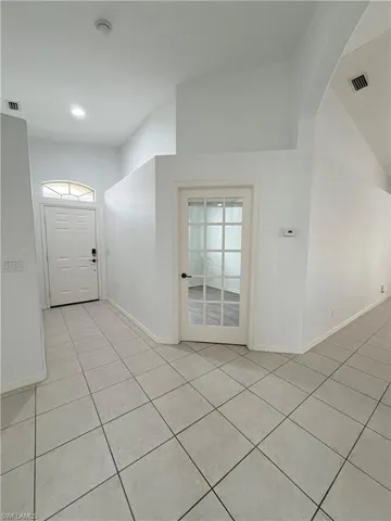 Entrance foyer featuring light tile patterned floors and recessed lighting. Easy access to 1st bedroom