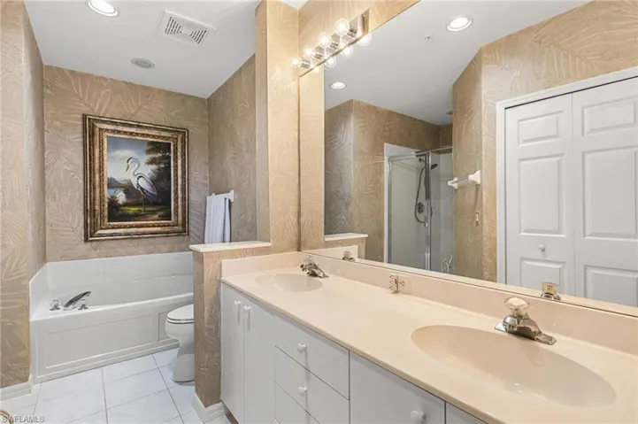Primary bathroom has a separate walk in shower and soaking tub, dual vanities.