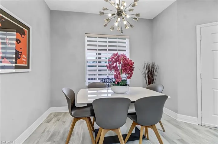 Dining space featuring light hardwood / wood-style flooring and a chandelier
