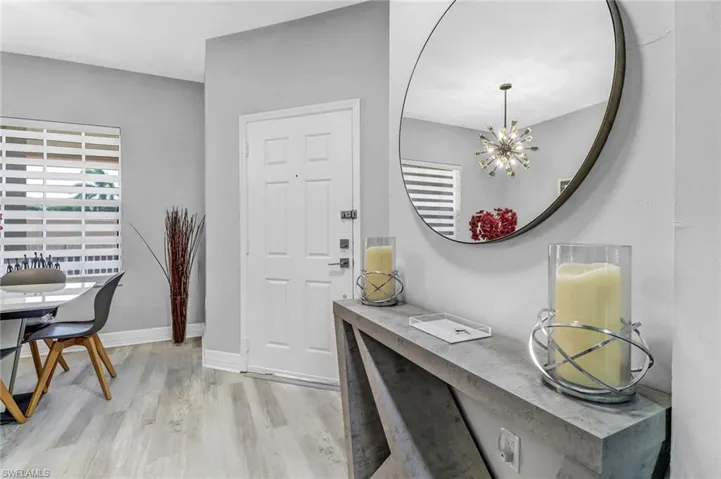 Entrance foyer featuring an inviting chandelier and light wood-type flooring