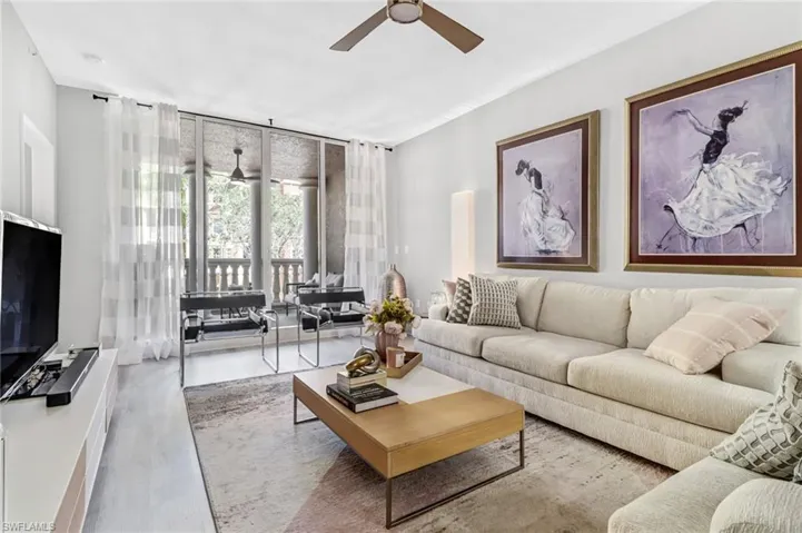 Living room with wood-type flooring and ceiling fan