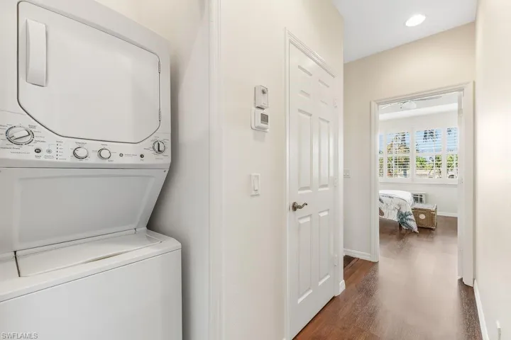 Laundry room located on the second floor hallway with a stacked washer / dryer