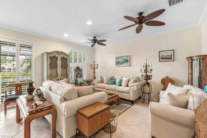 Living room with crown molding, light tile patterned flooring, plenty of natural light, a ceiling fan, and recessed lighting