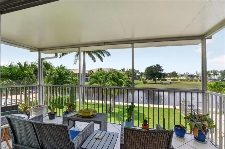 Screened lanai featuring a solid overhead roof, tiled flooring, and an aluminum railing