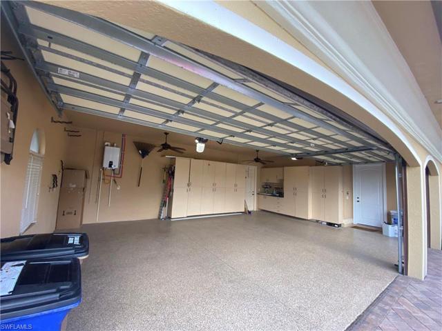 Three car garage with epoxy floors and lots of storage cabinets
