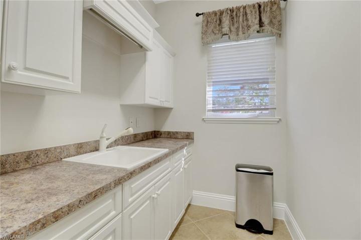 Laundry room with utility sink and lots of cabinet space.