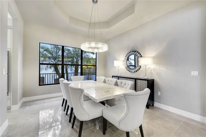 Full Dining Room View with Coffered Ceiling and Included Furnishings
