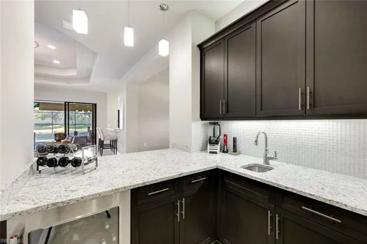 Wine Cooler, Ice Maker, Sink and Custom Finishes with Sit in Bar