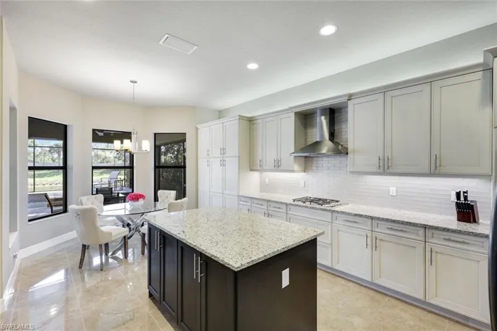 Two Tone Natural Gas Kitchen with Polished Porcelain Floors and Glass Backsplash