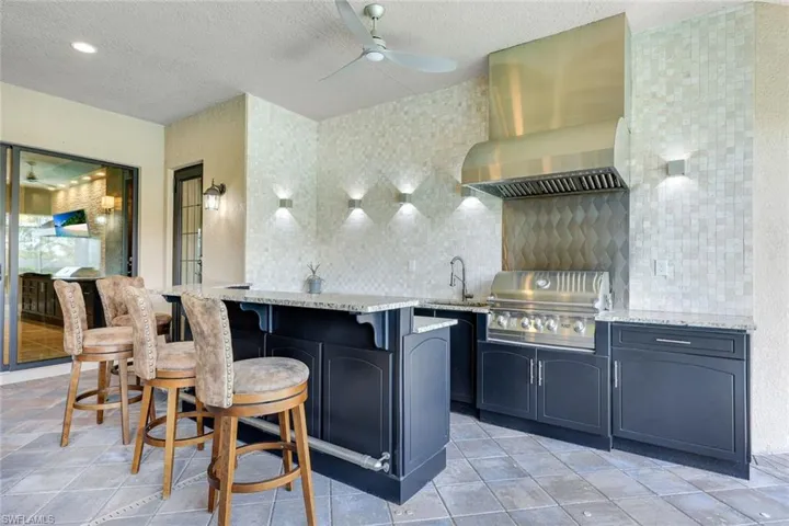Custom Natural Gas Outdoor Kitchen with Built in Grill, Bar Seating, Beverage Center, Ice Maker and Custom Lighting