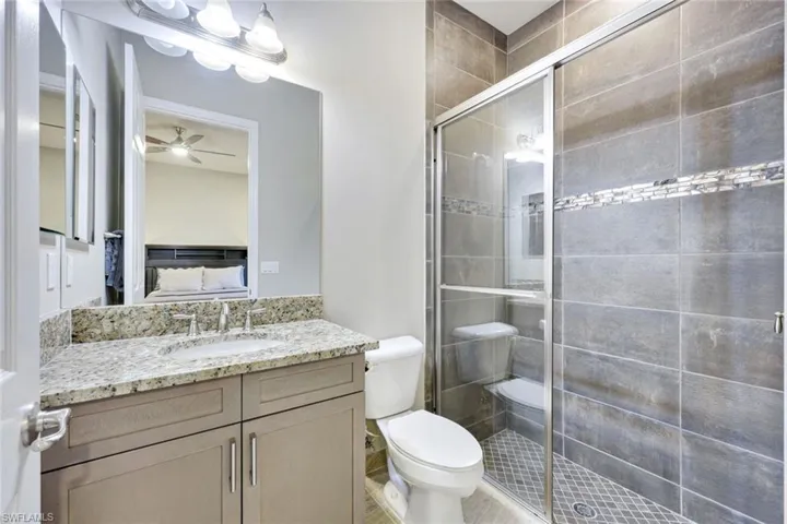 Full En Suite Bathroom with Floor to Ceiling Tile and Custom Finishes