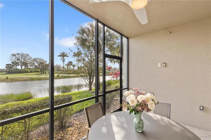 The screened lanai features a golf course and water view.