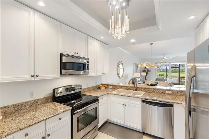 Well cared for and freshly painted cabinets, open to the living and dining area