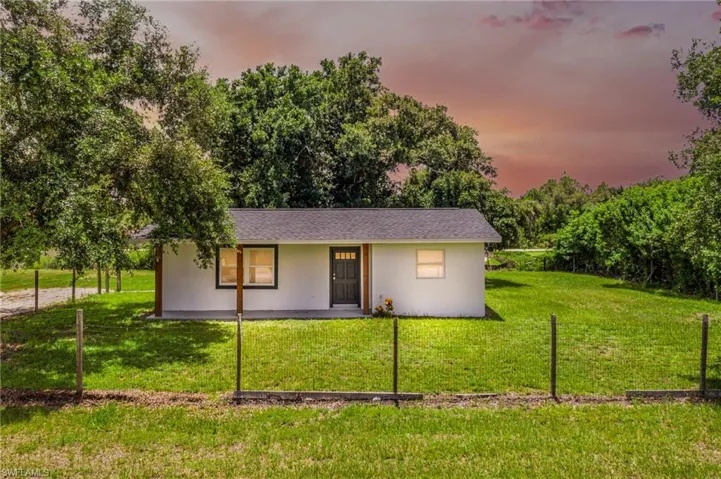 Ranch-style home with a lawn