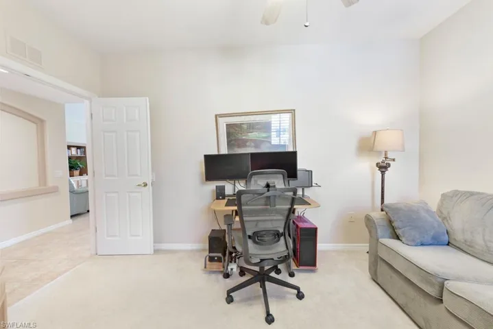 Office space featuring ceiling fan and light colored carpet